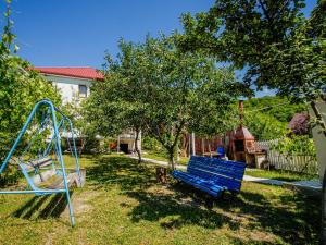a blue bench in a yard with a swing at guest hause "villa" in Dushetʼi