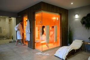a man standing in front of a room with a glass wall at Magister Apartmanház in Cserépfalu +31 photos