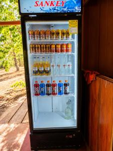 an open refrigerator filled with lots of drinks at Parque Indigo Nature Lodge, Rincón de la Vieja in Liberia