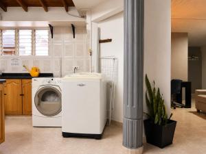 a kitchen with a washing machine in a kitchen at Coliving Compostela in Medellín