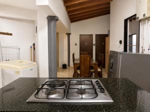 a kitchen with a stove top on a counter at Coliving Compostela in Medellín +127 photos