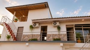 a balcony of a house with plants on it at Brisa y Lienzo - Hostal Boutique in Puerto Colombia +6 photos
