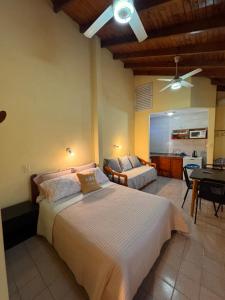 a bedroom with a large bed and a living room at HColon in Colón