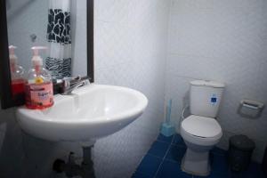 a bathroom with a white sink and a toilet at Cozy Apartment in Minca in Minca +21 photos