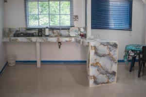 a kitchen with a counter top in a room at Cozy Apartment in Minca in Minca