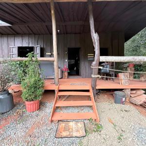 a ladder sitting on the porch of a house at La Cabaña de Don Tavo in Roble