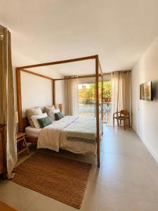 a bedroom with a canopy bed and a balcony at Chambre cosy in Viols en Laval