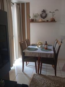 a dining room table with chairs and a table and a table and chairsktop at Small family apartment in Sao Sebastiao +7 photos
