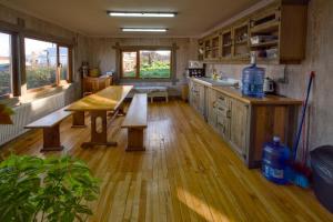 a kitchen with wooden floors and a table and benches at Casa Oxidada in Puerto Natales +22 photos