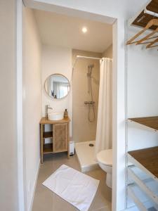 a bathroom with a toilet and a mirror at Chambre cosy in Viols en Laval