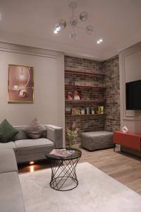 a living room with a couch and a tv at Tashkent city Gardens E2 block in Tashkent +13 photos