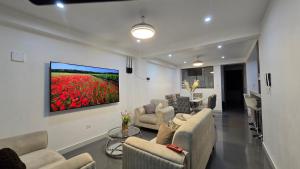 a living room with couches and a tv on a wall at 2 departamento ejecutivo capacidad 08 in Tacna