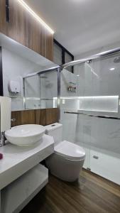a bathroom with a toilet and a glass shower at 2 departamento ejecutivo capacidad 08 in Tacna