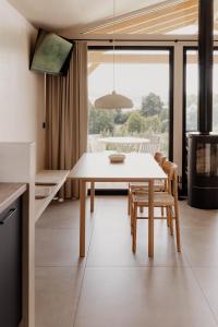 a kitchen and dining room with a table and chairs at Hüttenchalets Rhön in Geisa