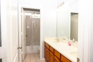 a white bathroom with a sink and a shower at Bluebonnet Retreat in Flower Mound +16 photos