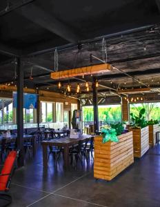 a restaurant with wooden tables and chairs and windows at Waterfront Hotel in Prairie du Chien