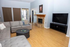 a living room with a couch and a fireplace at Bluebonnet Retreat in Flower Mound
