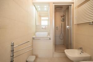 a bathroom with a sink and a toilet and a mirror at Aragonese Apartments in Casa Chiaiozza +29 photos