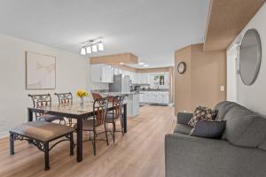 a living room and dining room with a table and a couch at Dells Paradise At Lighthouse Cove Condominiums in Wisconsin Dells