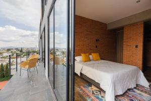 a bedroom with a bed on a balcony at TORRE ARCARTI Internet alta velocidad y estacionamiento in San Baltasar