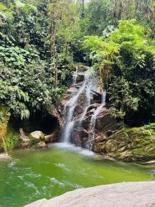 a waterfall in the middle of a pool of water at Aruma House - Departamento de 2 Dormitorios in Tena