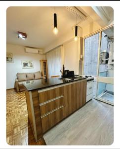 a kitchen with a counter top and a living room at La mejor opcion en BA in Buenos Aires