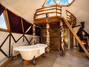 a bathroom with a tub in a room with a tent at Soho-place in Bran +104 photos