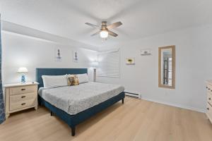 a bedroom with a blue bed and a ceiling fan at Dells Suite Dreams At Lighthouse Cove Condominiums in Wisconsin Dells +103 photos
