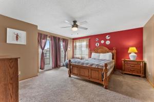 a bedroom with a bed and a ceiling fan at Dells Family Stacation in Wisconsin Dells +68 photos