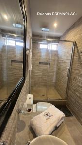 a bathroom with a shower and a sink at OXALAND HAUs in Oxapampa +5 photos