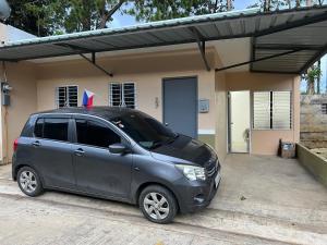 a gray minivan parked in front of a house at Alexeis Place in Manolo Fortich