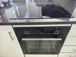 a black oven with a microwave on top of it at DURBAN BEACHFRONT Tenbury 903 in Durban +61 photos