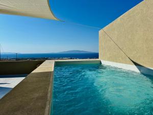 a swimming pool on the side of a building at Bevimar Suites with Private Pool and Non Heated Jacuzzi in Santorini