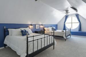a blue bedroom with two beds and a window at Austin Apartments by Andes STR in Austin +55 photos