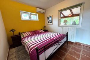 a bedroom with a bed and a window at Villa Malnar in Vrh +15 photos