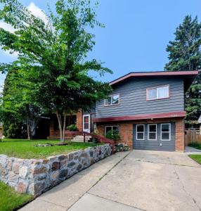 a house with a stone retaining wall at Mountview Maison in Red Deer