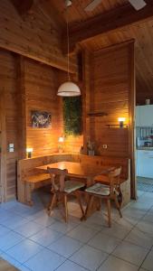 a large wooden room with a table and chairs at Chalet le Chal'Heureux in Mauroux