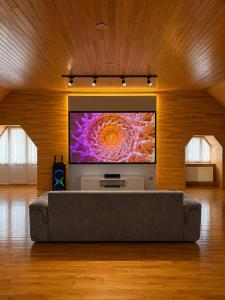 a living room with a large flat screen tv on a wall at Bilgah Coast Villa in Baku