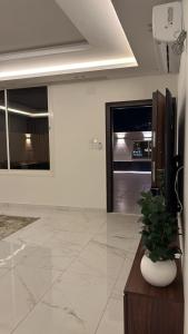 a living room with a potted plant on a table at STAYs ستايز in Medina