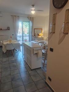 a kitchen with a table and a refrigerator in a room at Salento Garden Relax in Merine