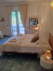 a bedroom with a large bed and a window at Salento Garden Relax in Merine