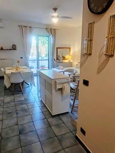 a kitchen with a table and a refrigerator in a room at Salento Garden Relax in Merine