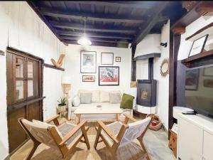 a living room with a couch and a table and chairs at LITTLE TOWER in Potes