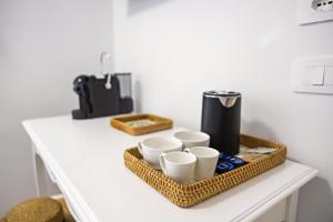 a tray with cups and a coffee maker on a counter at Annalì in Trentinara
