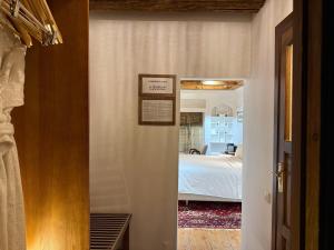 a hallway leading to a bedroom with a bed at Usman Heritage in Bukhara +62 photos