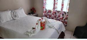 a bedroom with a white bed with decorations on it at Sailor's Gem in Tortola Island