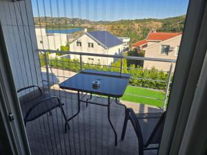 a blue table and chairs on a balcony with a view at Vesna Lake Apartments in Veles