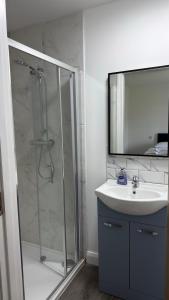 a bathroom with a shower and a sink and a mirror at Dwellinghouse, Inishmore in Ourtnagapple +17 photos