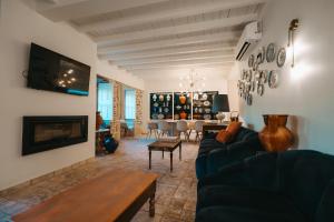 a living room with a couch and a fireplace at Valadouro Dona Adelaïde With a Pool in Espinhosa