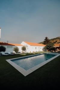 a swimming pool in the yard of a house at Valadouro Dona Adelaïde With a Pool in Espinhosa